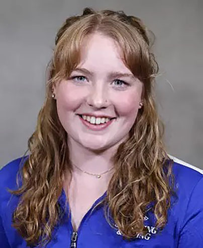 Maggie smiling in a swim team roster photo
